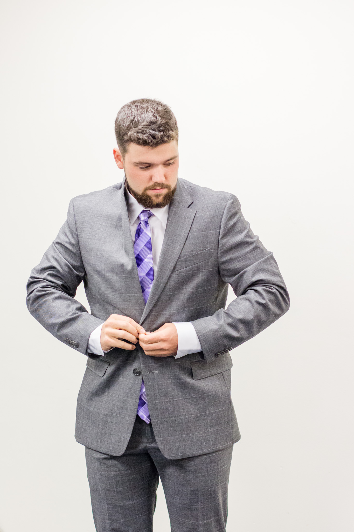 Grooms gray suit with purple plaid tie