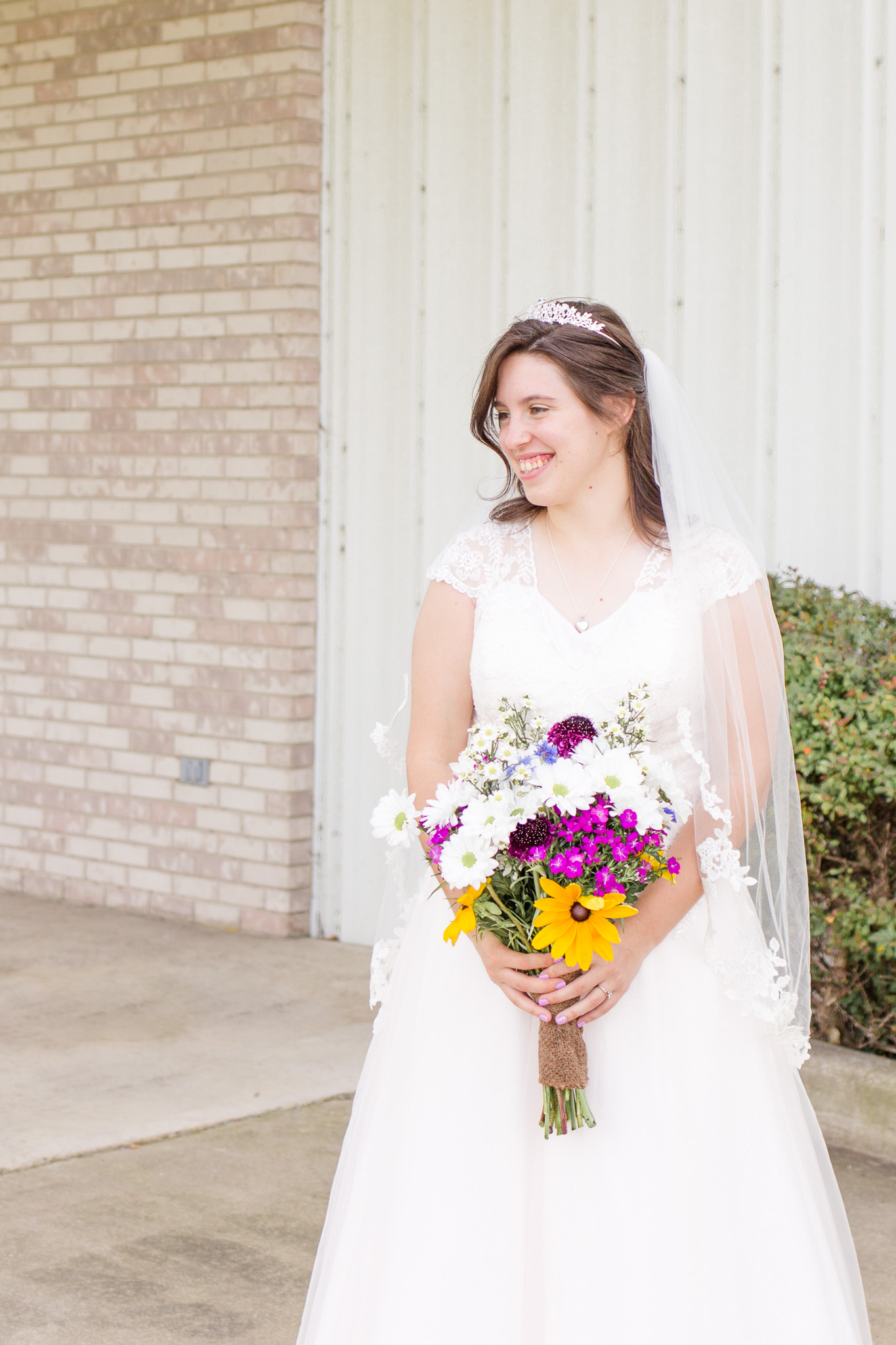 Beaded blush wedding dress and wildflower wedding bouquet
