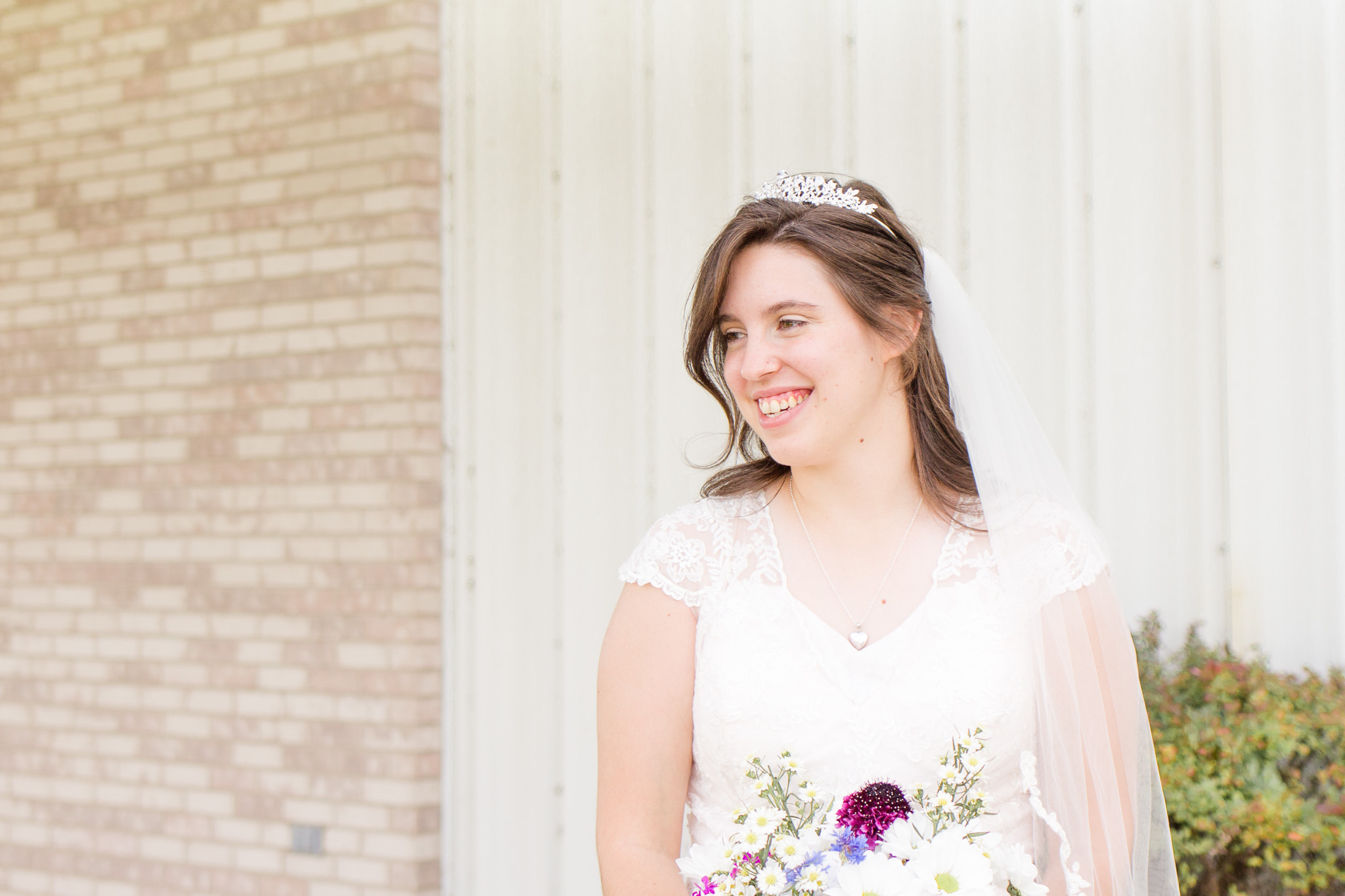 Beaded blush wedding dress and wildflower wedding bouquet