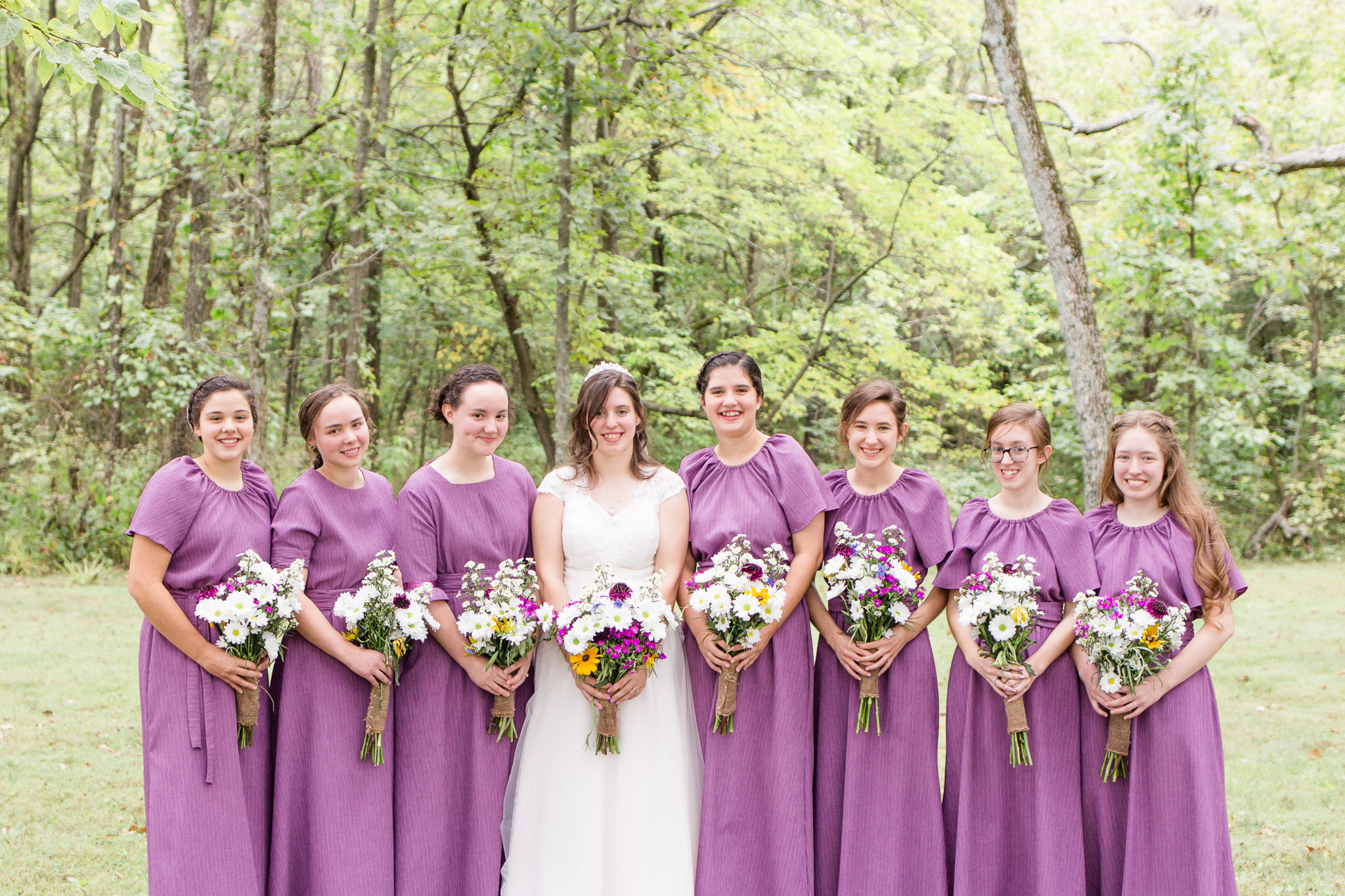 Purple bridesmaid dresses and wildflower wedding bouquets