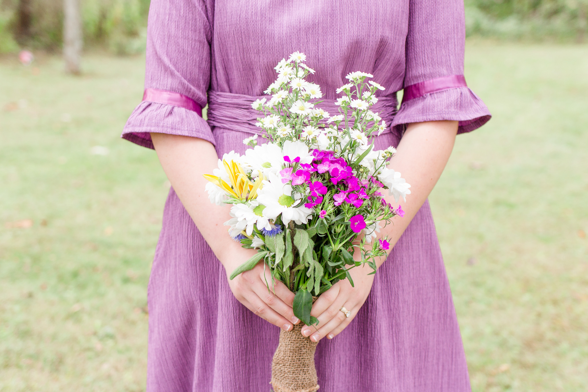 Purple bridesmaid dress with wild flower wedding bouquet